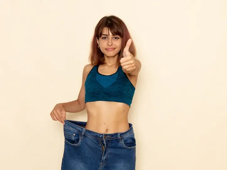 front-view-young-female-with-fit-body-blue-shirt-jeans-smiling-light-white-wall Fogyás beindítása – 10 lépéssel! Testsúlycsökkentés 