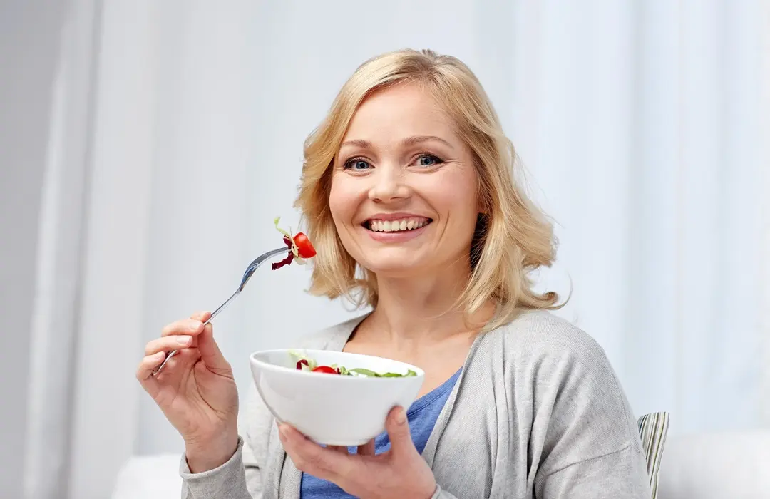 healthy-eating-dieting-people-concept-smiling-young-woman-eating-vegetable-salad-home Változókori étrend – így táplálkozz! Szupertápanyagok 