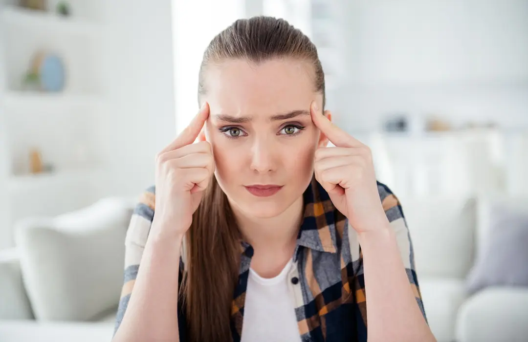 hoto-young-lady-talk-video-call-online-webcam-think-hold-fingers-temples-stay-home-indoors ADHD tünetei és kezelése Mentális egészség 