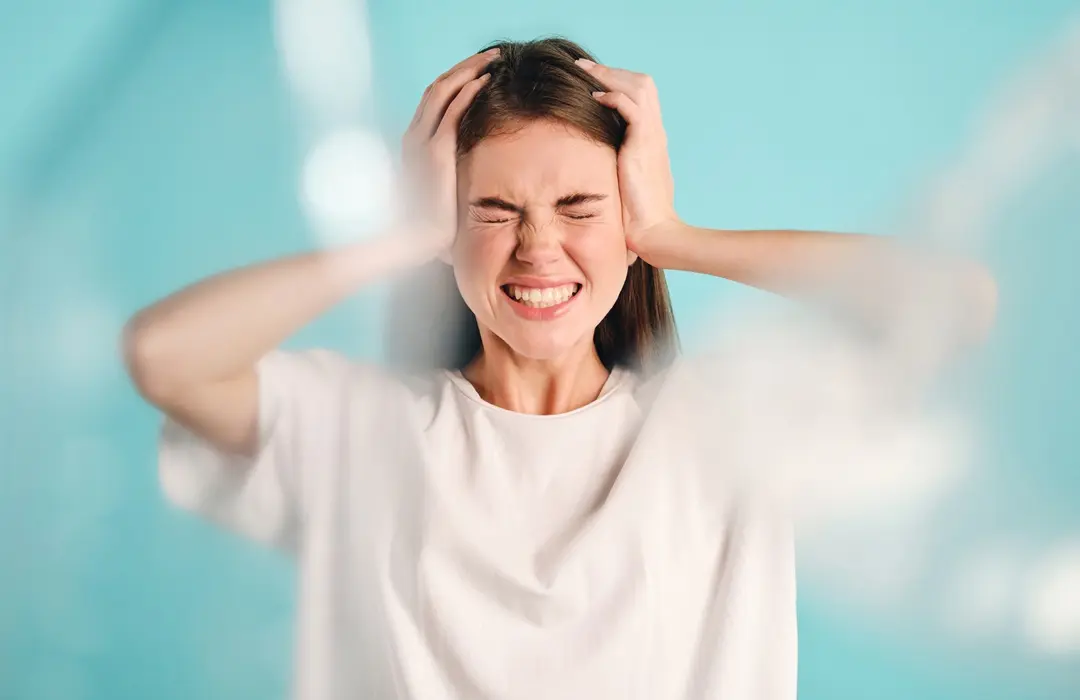 irritated-girl-angrily-holding-hands-head-with-plastic-around-colorful-background-isolated ADHD tünetei és kezelése Mentális egészség 