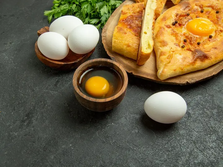 top-view-tasty-egg-bread-baked-with-greens-grey-background-bread-bun-dough-food-breakfast Magas koleszterin – Káros a tojás? Emésztés 